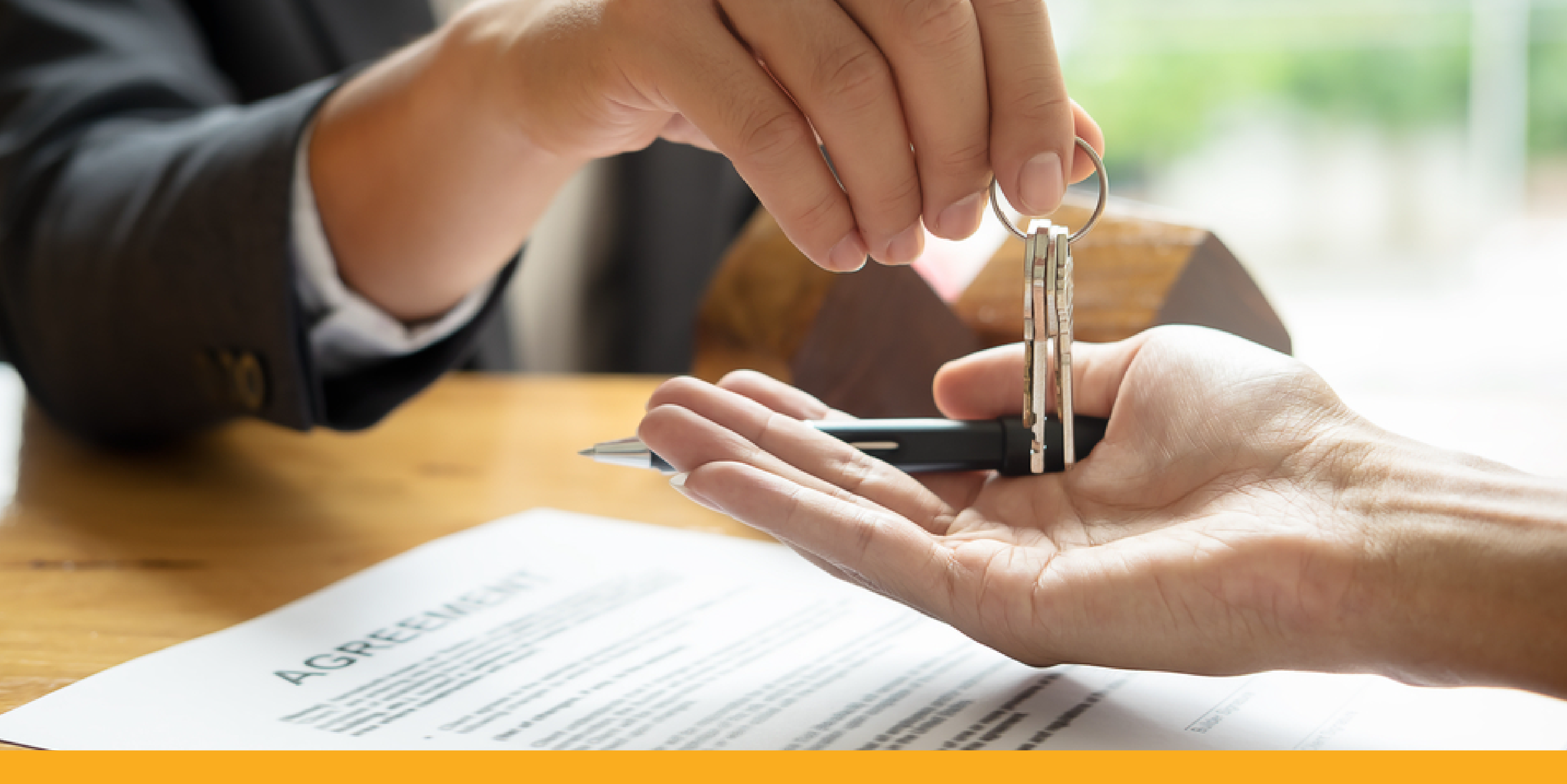 A person receiving keys for a house after a real estate closing